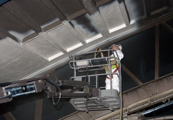 Soot Removal Film in action - spraying on ceiling industrial hall