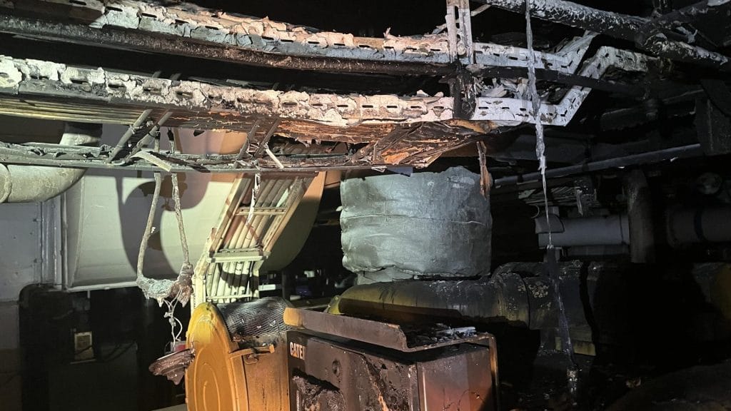 Engine room of a ship covered in soot after a fire