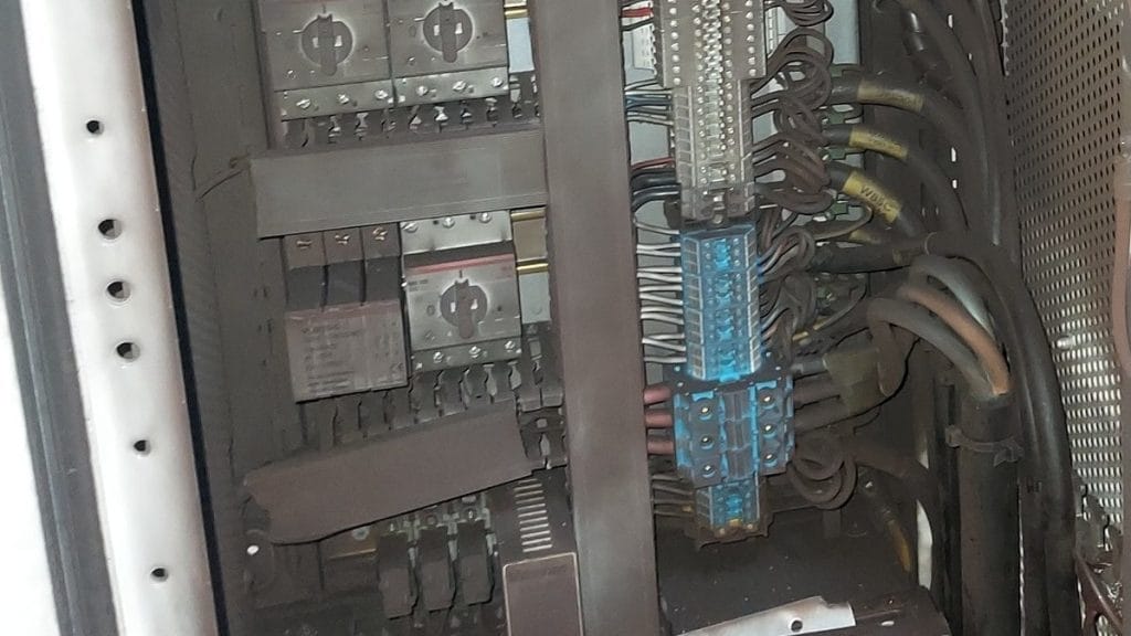 Sooty control cabinet before renovation after a fire