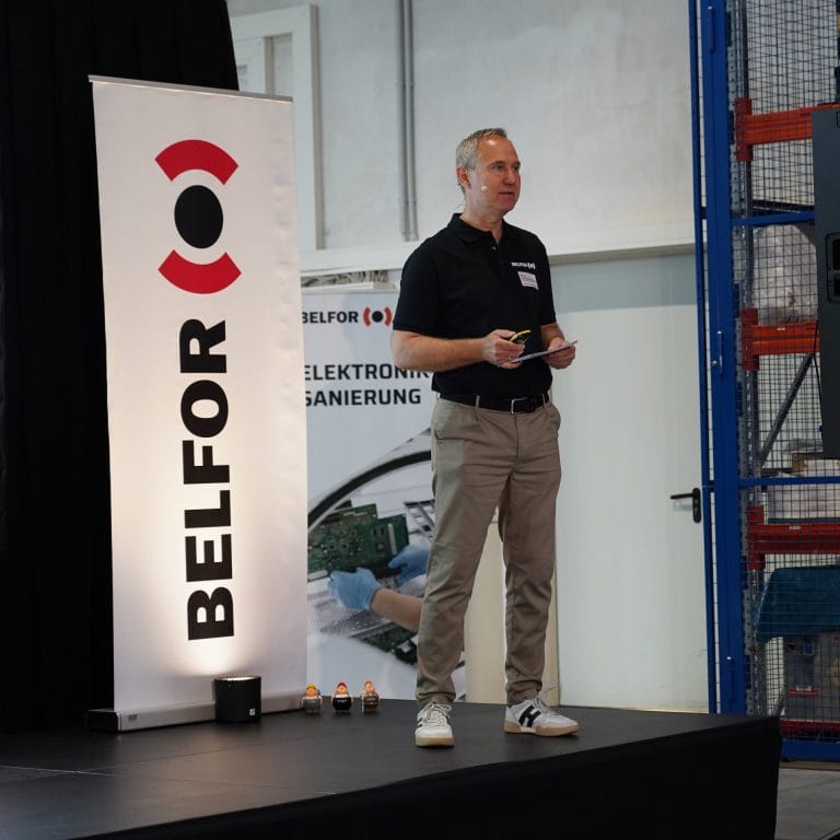 Martin Schachtschneider standing in front of a BELFOR Banner